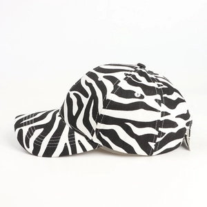 Side view detail of zebra print baseball cap showing cotton fabric and stitching details