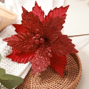 Glittery red poinsettia Christmas flower on a cozy tray for festive tree decoration