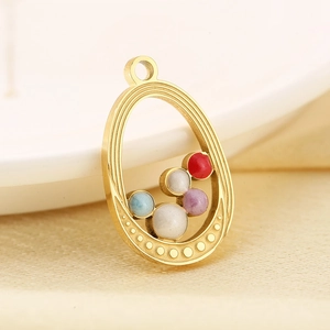 Macro shot of 18K gold star charm with colorful beads for DIY jewelry design