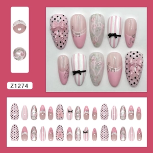 Pink French cat-eye press-on nails with 3D bow, music notes and polka dot patterns