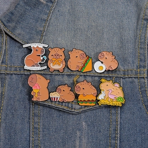 Set of 8 cute capybara enamel pins featured on a denim jacket pocket for bag and clothes