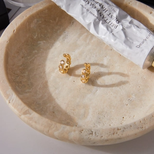 Classic 18K gold plated stainless steel hoops with white zircon set in a marble bowl