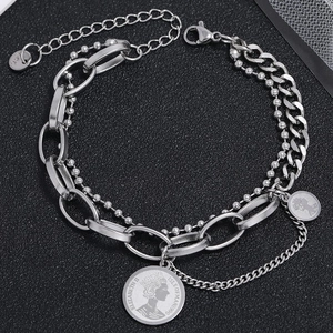 Macro view of multi-layer stainless steel chain bracelet with retro coin pendant