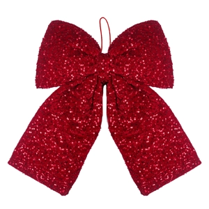 Detailed view of a large red sequined Christmas bow ornament with fine hanging string