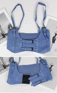 Detail of blue denim corset belt with adjustable metal buckles and velcro closure