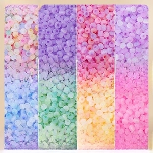Macro detail of 4mm multi-color ice-glass cat-eye round beads for DIY jewelry making
