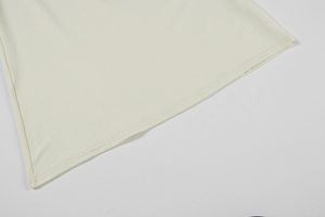 Detail of double-needle stitching on off-white lace dress hem showing high quality fabric