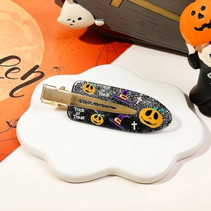 Detail of Halloween hair clip with pumpkin and wizard hat on a ceramic plate