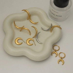 Minimalist moon-shaped stainless steel stud earrings in gold and silver finish