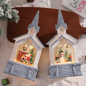 Detail of light-up Christmas church figurines with Santa and snowman scenes