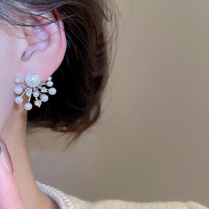 Macro view of sterling silver stud earrings with pearls and sparkling cubic zirconia