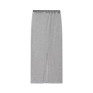 Detailed view of grey maxi skirt with slit hem and plaid waistband patchwork detail