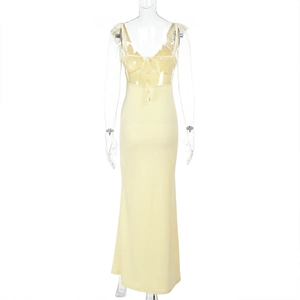 Detail of light yellow slim fit maxi dress featuring ruffled lace and tie-up chest design