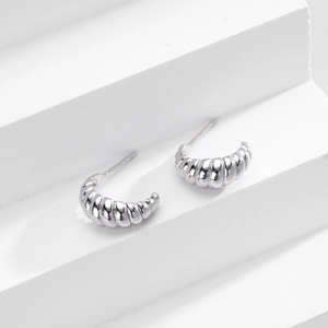 Macro view of S925 sterling silver croissant C-shaped stud earrings with twisted texture