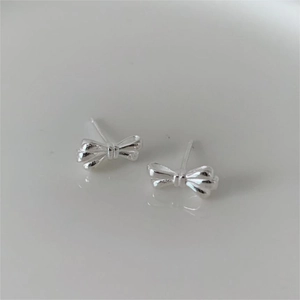 Minimalist 925 sterling silver bow knot stud earrings with a polished metallic finish