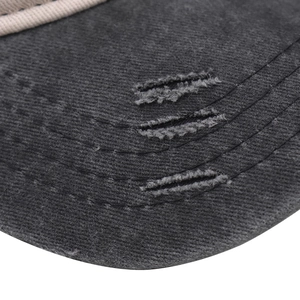 Detail of distressed grey cotton cap featuring triple frayed holes and vintage cream rope trim