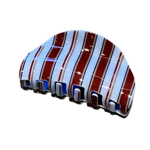 Vintage blue and brown striped hair claw clip in a classic semi-circular shark clip design