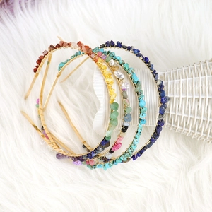 Detail of handcrafted gold double-row headbands with natural crystal stone winding