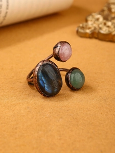 Macro shot of vintage copper ring featuring labradorite, rose quartz and green aventurine