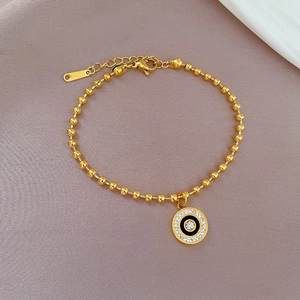 Titanium steel bracelet with gold beads and roman style crystal circle pendant