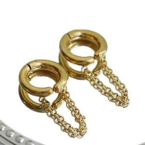 Minimalist gold double hoop tassel earrings with chains on reflective surface