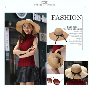 Detail view of foldable wide-brim straw hat with black ribbon and matching sunglasses