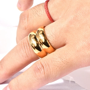 Close-up of a wide 18K gold plated stainless steel ring on a finger with mirror finish