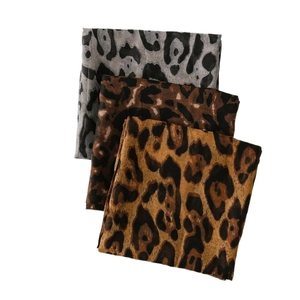 Three oversized leopard print scarves in grey, brown, and gold cotton-linen blend