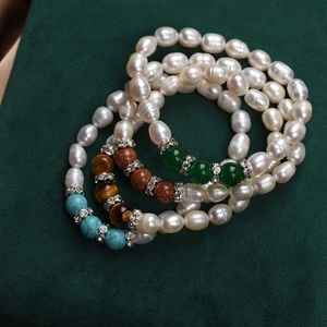 Handmade freshwater pearl bracelets with natural gemstone beads on luxury green velvet