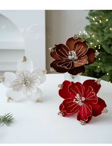 Detail of glitter velvet magnolia flowers in red, white and brown for Christmas decor