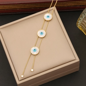 Golden stainless steel necklace with blue evil eye pendants and white mother-of-pearl