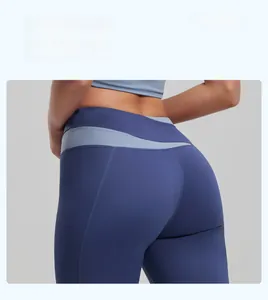 Detail of high-waisted yoga shorts in dark blue with light blue patchwork and lift effect