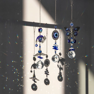 Three crystal evil eye suncatchers casting rainbow light on a clean background