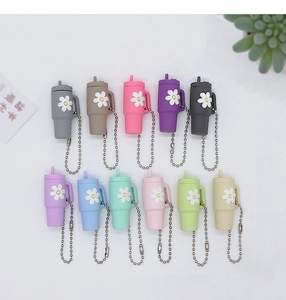 Macro view of 11 colorful mini cup keychains with daisy patterns and metal bead chains