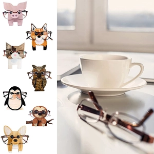 Detailed view of creative wooden animal eyeglass holders for office and home desk decor
