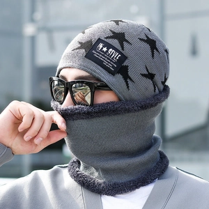 Outdoor shot of grey winter knitted hat and neck gaiter set with star pattern