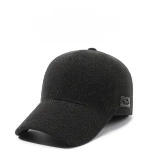 Detail view of charcoal wool baseball cap showing thick warm fabric and side metal emblem