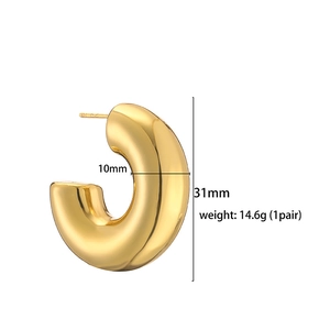 Detail view of 31mm chunky gold C-shaped hoop earrings with 10mm tube thickness and weight