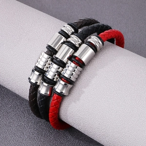 Detailed close-up of triple-layer braided leather bracelet with silver metal beads