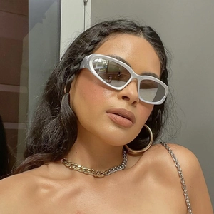 Close-up of silver futuristic steampunk sunglasses with cat-eye metallic frames