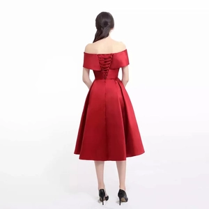 Detailed back view of red off-shoulder midi dress featuring a criss-cross lace-up design