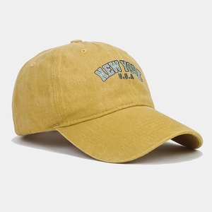 Detailed embroidery on vintage washed canvas cap in mustard yellow color