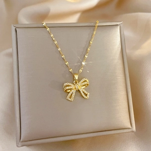 Elegant gold butterfly necklace with zircon crystals on a luxury jewelry box display