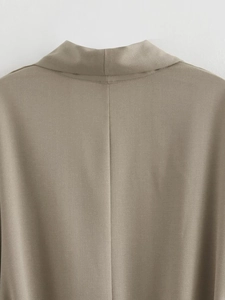 Detailed back view of khaki kimono top neckline and central seam in woven fabric