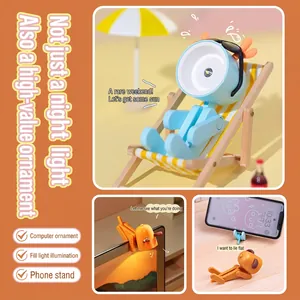 Mini LED pet night light and phone stand with adjustable limbs in blue and orange