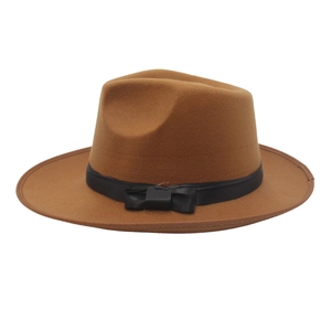Detail of camel wool fedora hat featuring a classic black ribbon band and elegant bow