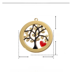 Detail of life tree pendant in gold finish with red enamel heart and rhinestone settings