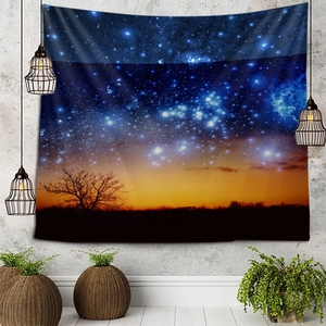 Detail view of starry sky tapestry with blue galaxy and tree silhouettes on a wall