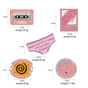 Pink enamel pins set with music tape and cat designs featuring dimensions and weights