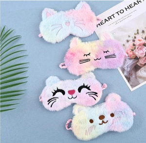 Close-up of four colorful plush sleep masks with cute cartoon animal embroidery details